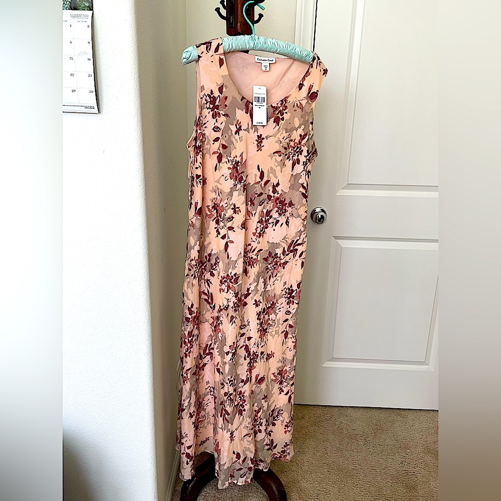 Size 16 peach sleeveless long lined dress with floral design and original tag.